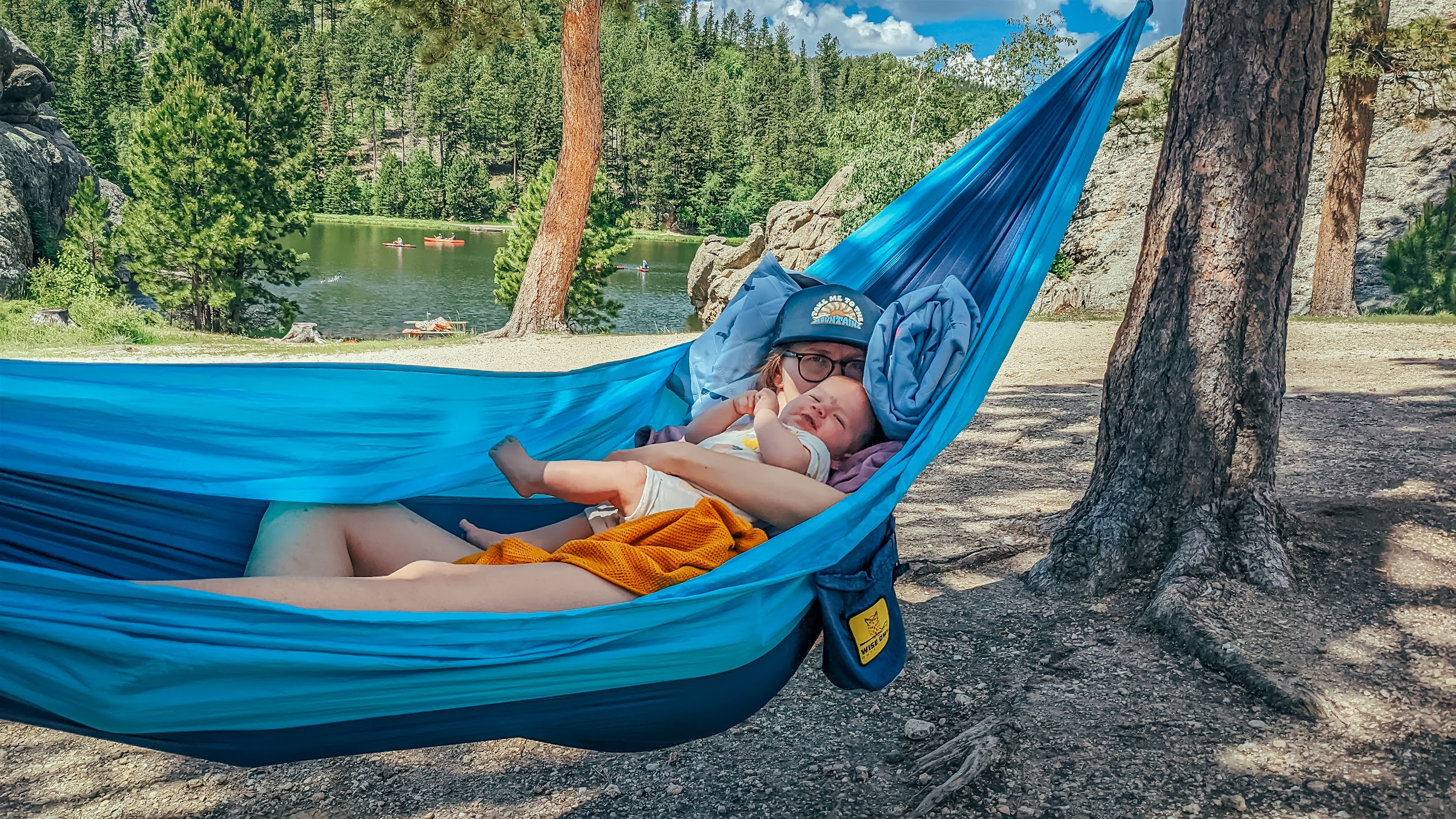 Ula and baby relaxing together in a blue hammock